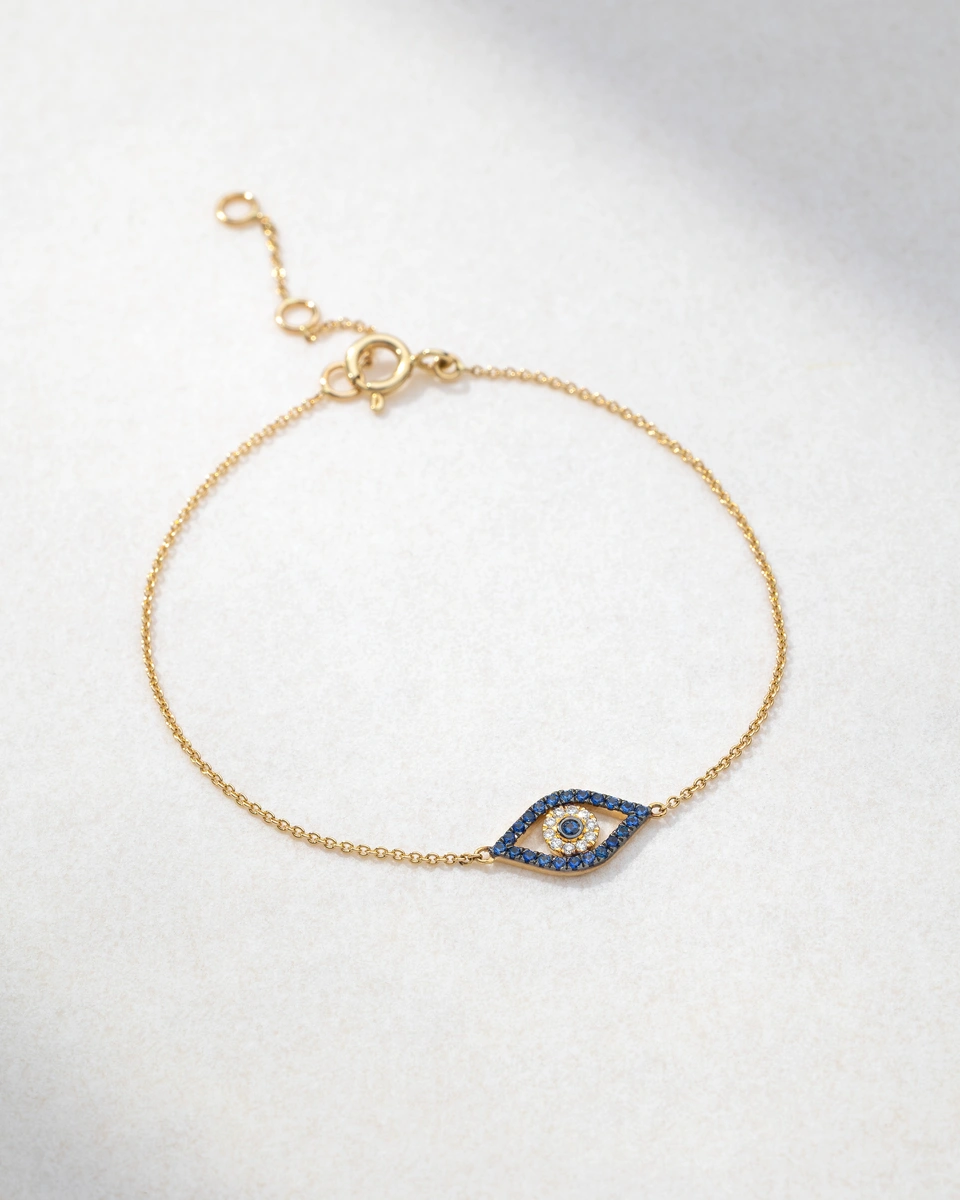 Bracelet in 18K Yellow Gold with White Brilliant Diamonds and Sapphires in Evil Eye Design