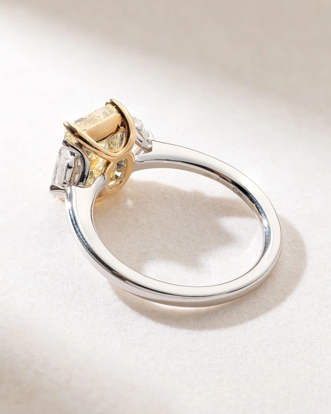 Exquisite 18K White Gold Ring with a Fancy Yellow Radiant Diamond and Two Trapezoid Diamonds
