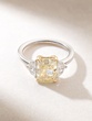 Exquisite 18K White Gold Ring with a Fancy Yellow Radiant Diamond and Two Trapezoid Diamonds