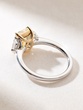 Exquisite 18K White Gold Ring with a Fancy Yellow Radiant Diamond and Two Trapezoid Diamonds